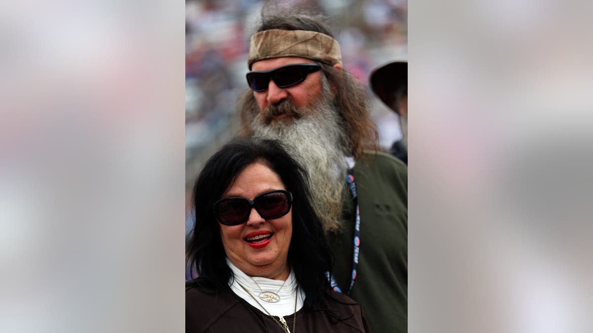The cast of Duck Dynasty in a camouflage four wheeler.