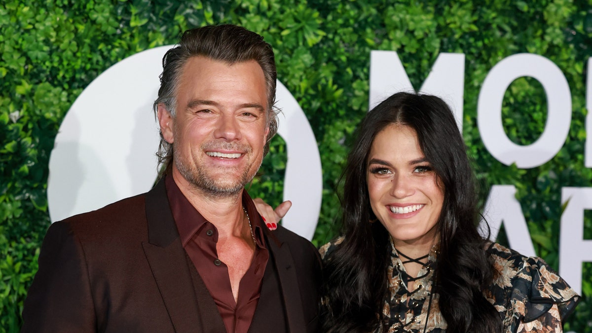 Josh Duhamel and his wife at a red carpet event