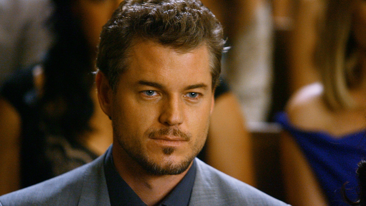 Eric Dane looking serious as Dr. Mark Sloan in a blue suit on "Grey's Anatomy"