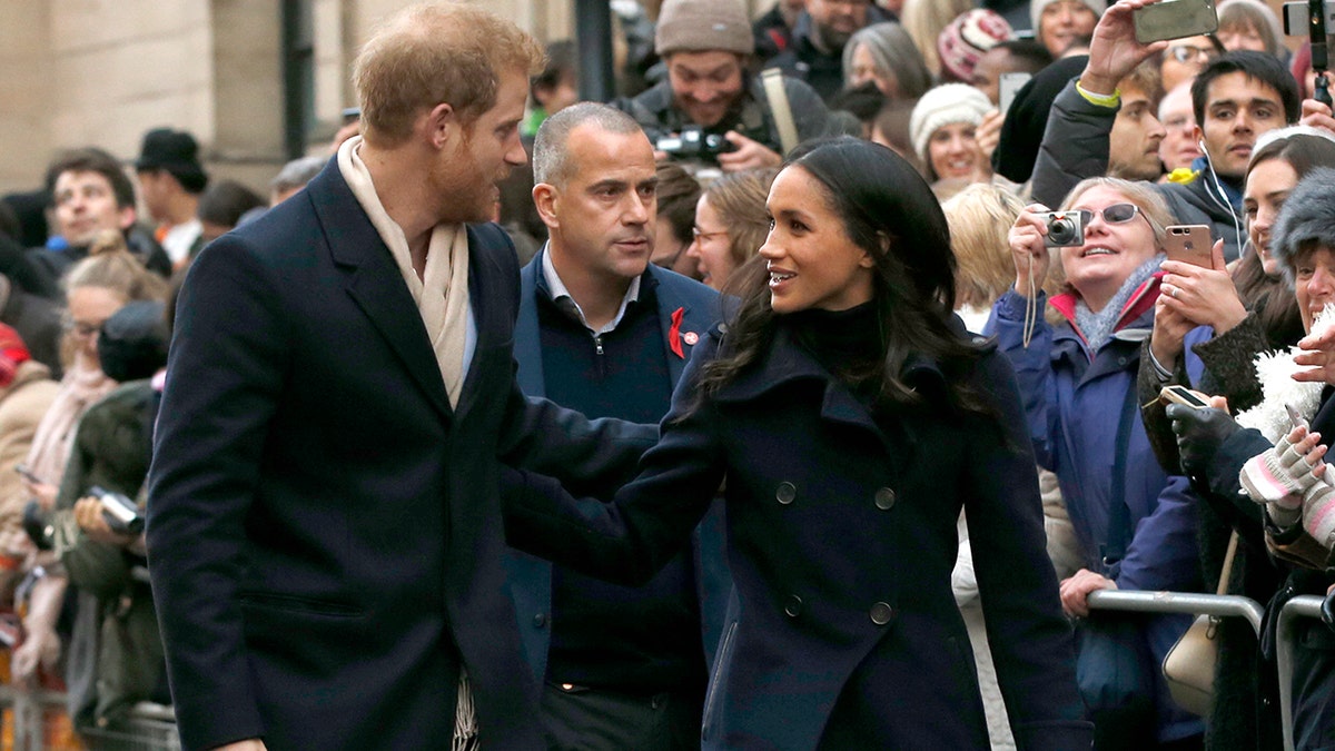 Britain's Prince Harry and his fiancee Meghan Markle arrive at the Terrence Higgins Trust World AIDS Day charity fair, in Nottingham, England, Friday, Dec. 1, 2017. The couple are taking part in their first official visit together, choosing to raise awareness of HIV/AIDS with a visit to a youth project in Nottingham.(AP Photo/Alastair Grant)
