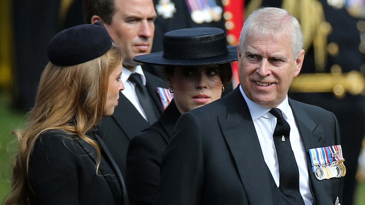 Princess Beatrice, Peter Phillips, Princess Eugenie, and Prince Andrew standing and talking at Wellington Arch.