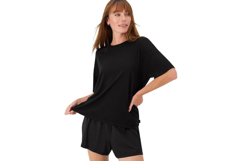 A woman modeling black short pajamas.