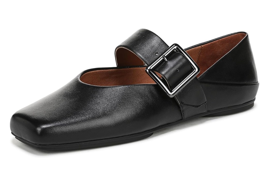 A black leather Mary Jane flat shoe with a square toe and a silver buckle on the strap.