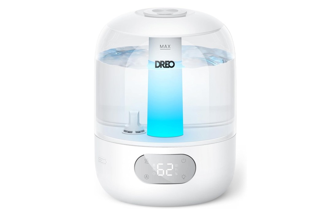 A white Dreo humidifier with a digital display showing "62" and a glowing blue light inside the water tank.