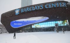 NEW YORK, NEW YORK - FEBRUARY 23: A person walks past the Barclays Center as snow falls during a blizzard on February 23, 2026 in Downtown Brooklyn in New York City. The northeast U.S. is bracing for an intense nor'easter with blizzard conditions, heavy snow, and strong winds. New York City Mayor Zohran Mamdani announced a state of emergency for NYC and issued a travel ban beginning at 9 p.m. tonight, and ending at 12 p.m. on Monday. NYC could get more than a foot of snow with up to two feet on Long Island and in parts of New Jersey. (Photo by Michael M. Santiago/Getty Images)