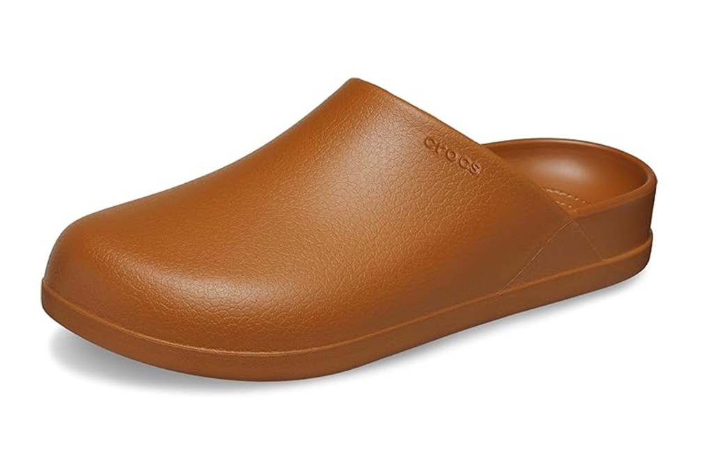 A brown Crocs Classic Clog shoe on a white background.