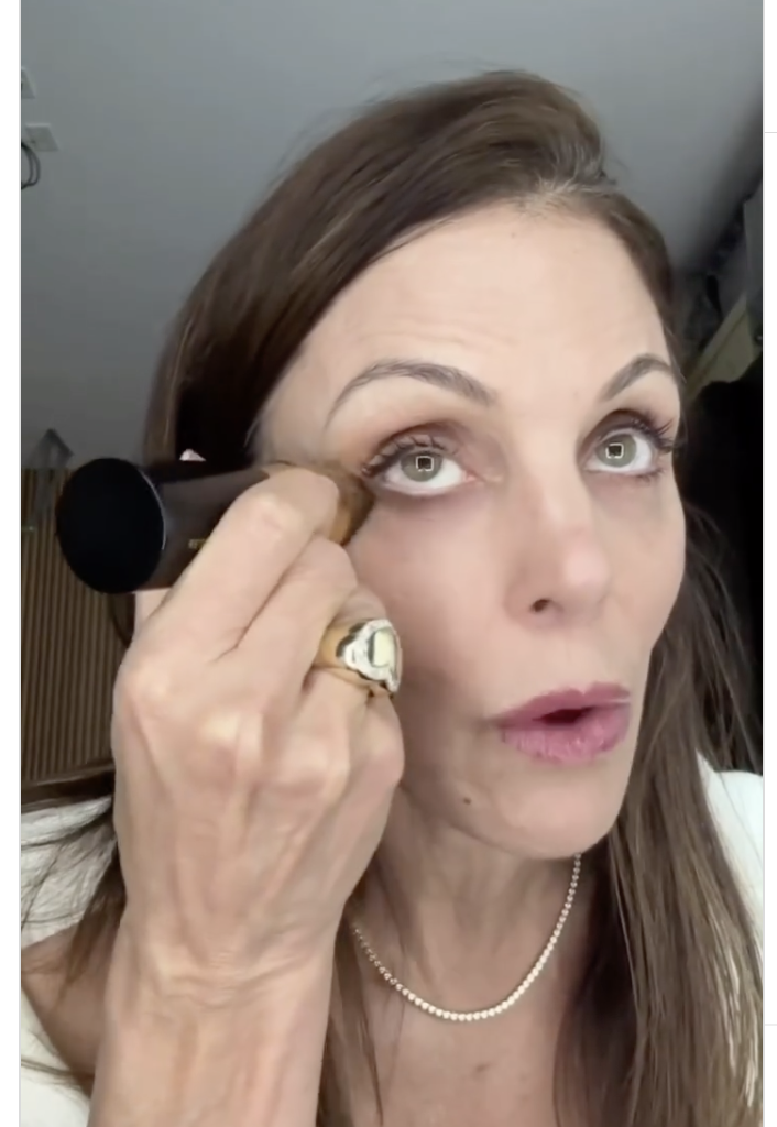 Bethenny Frankel applying an eye makeup product.