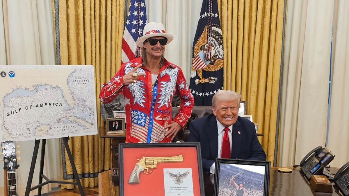 Kid Rock wearing a patriotic suit in the Oval Office with Trump