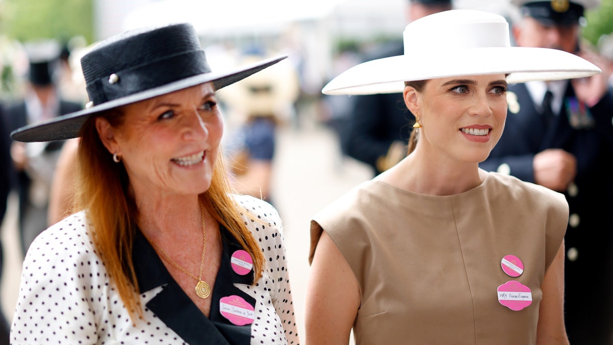 Sarah Ferguson and Princess Eugenie standing at a racecourse.