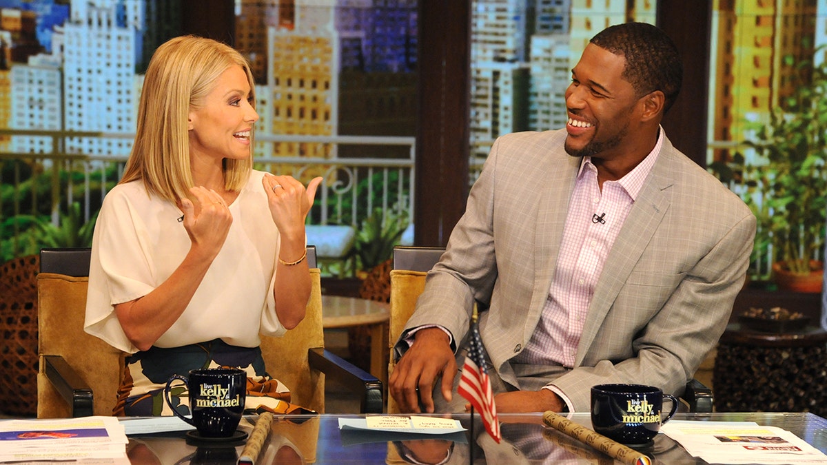 Kelly Ripa and Michael Strahan hosting "Live with Kelly and Michael" in July 2013.