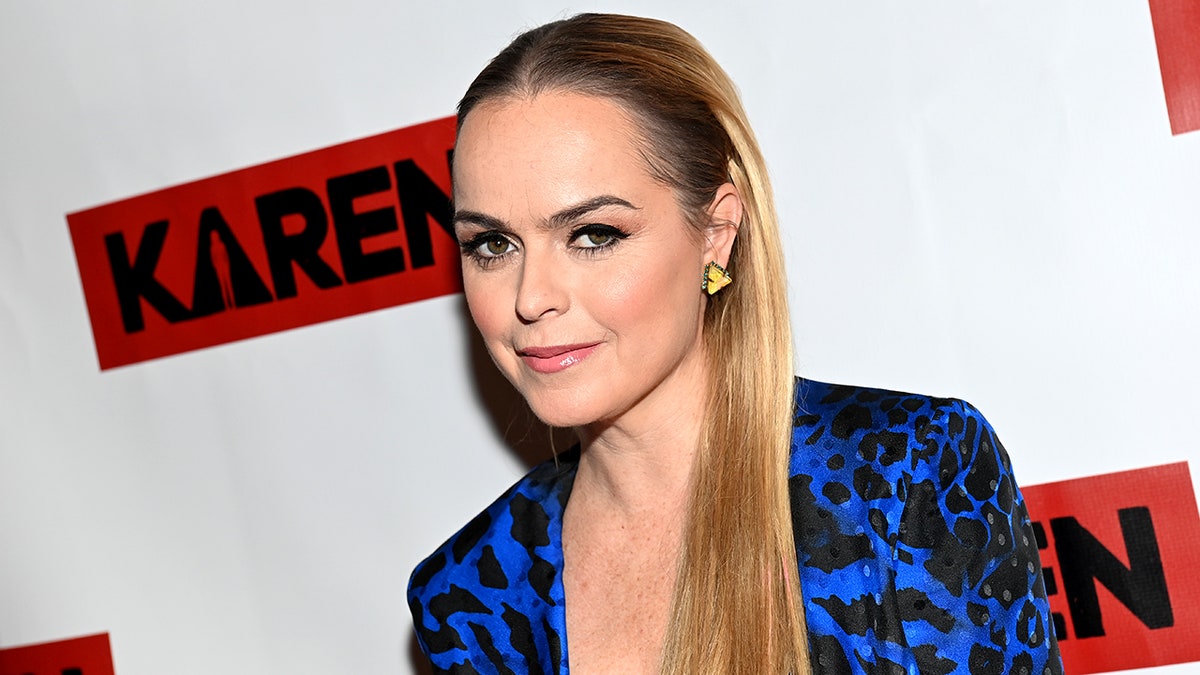 Taryn Manning in an electric blue and black dress oft smiles on the carpet for "Karen"