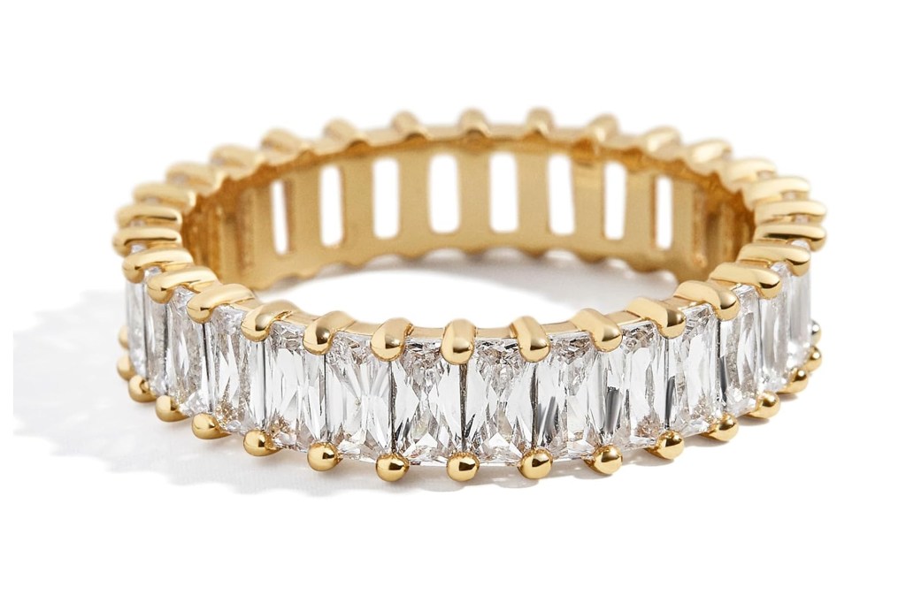 Gold eternity ring with baguette-cut diamonds.