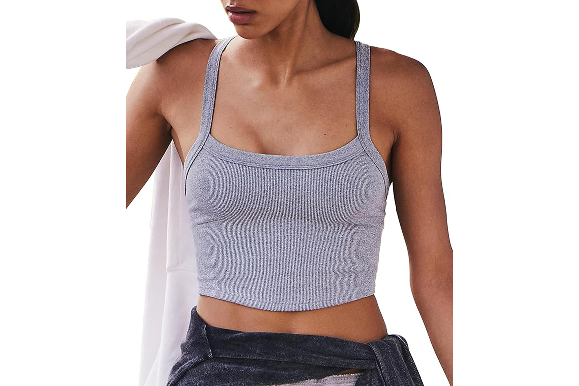 A woman wearing a gray ribbed crop top with thin straps.