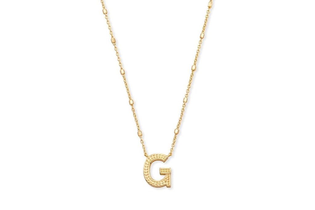 Gold necklace with a textured capital "G" pendant.