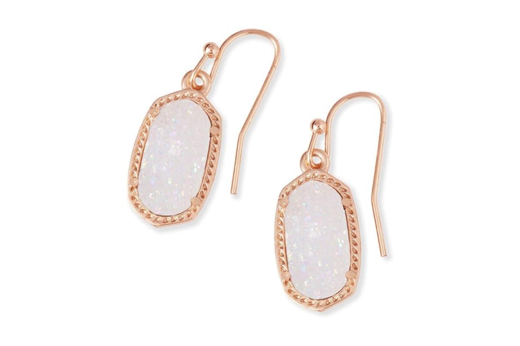 Rose gold hexagonal earrings with white iridescent centers.