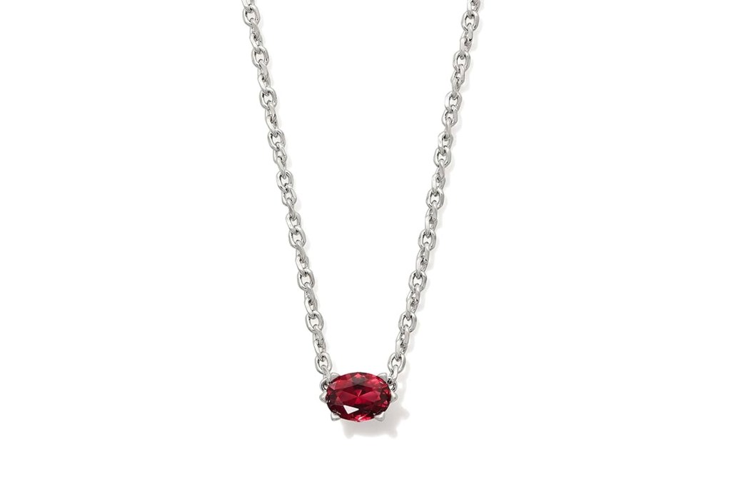 Silver chain necklace with an oval red gemstone.