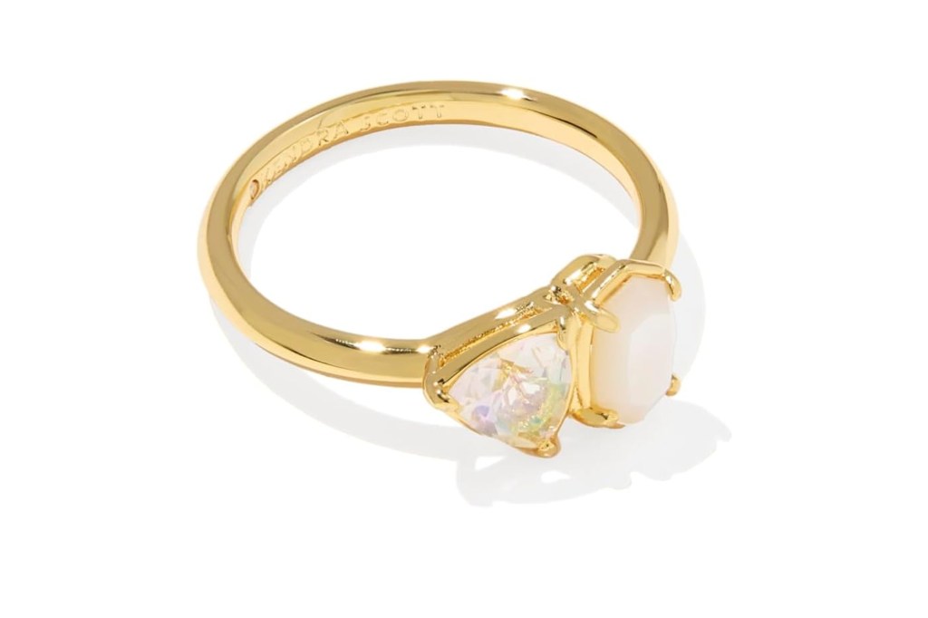 Kendra Scott gold ring with one iridescent triangle stone and one oval opalescent stone.