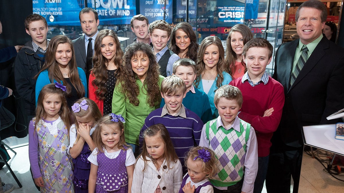 The Duggar family posing for a portrait.