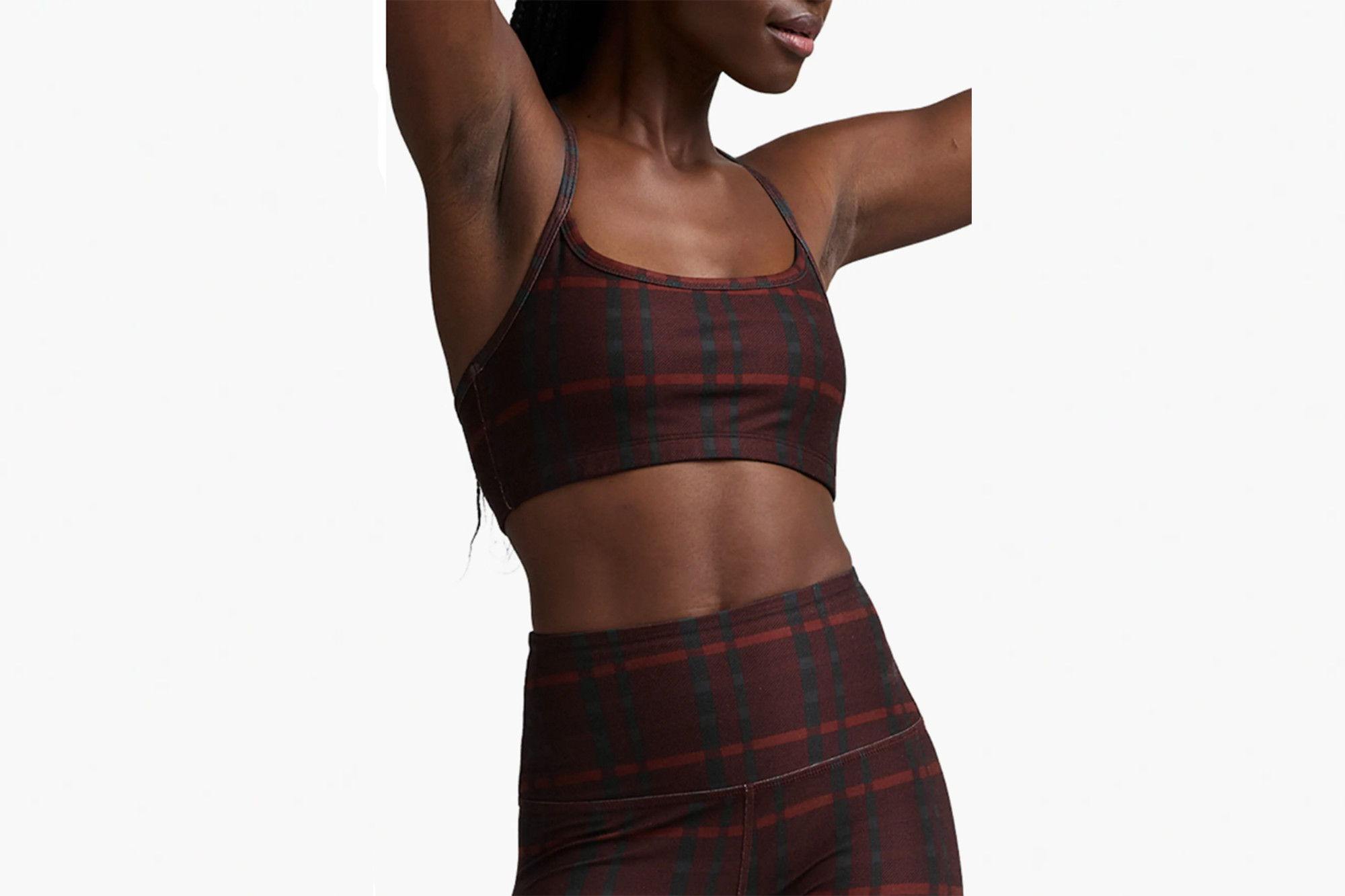 Woman wearing a plaid bra and leggings set.