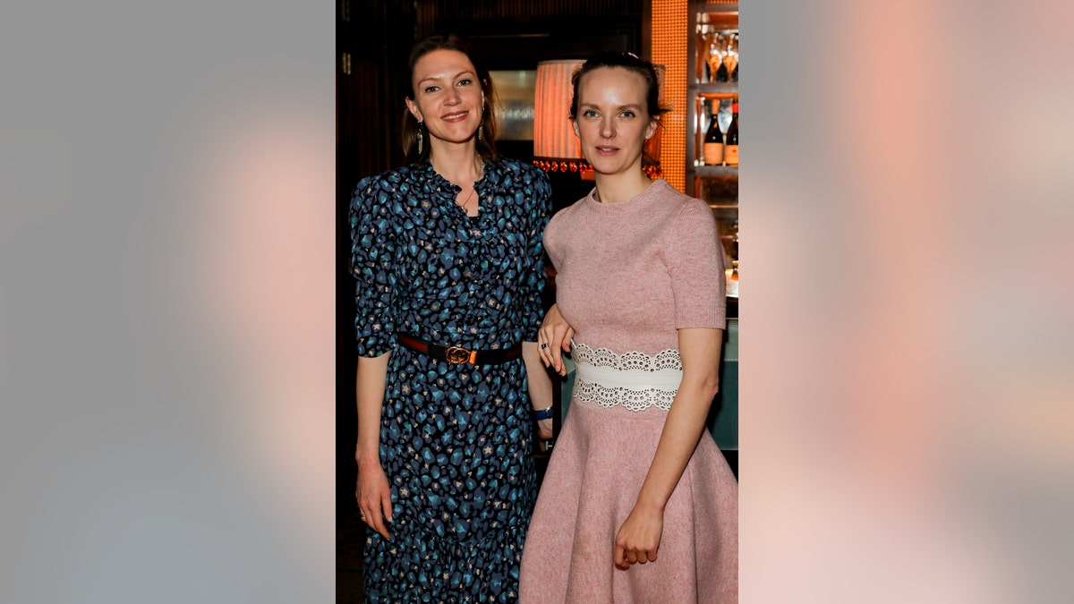 Charlotte Griffiths with a friend in formal wear at a London engagement.