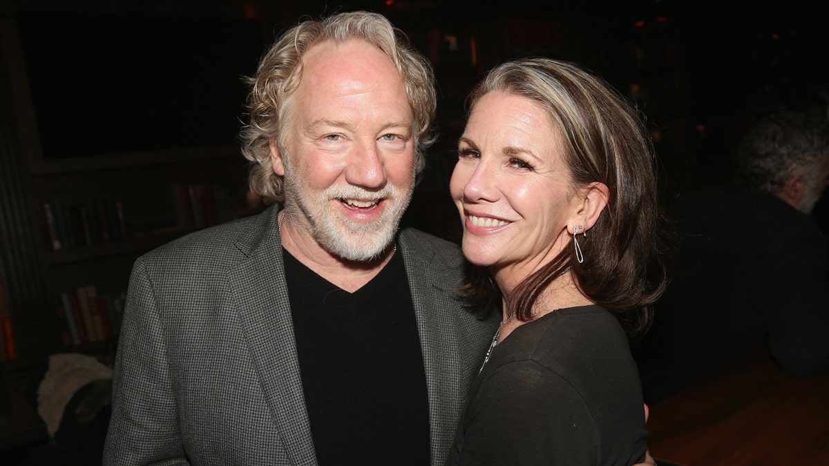 Timothy Busfield and wife Melissa Gilbert smile together.