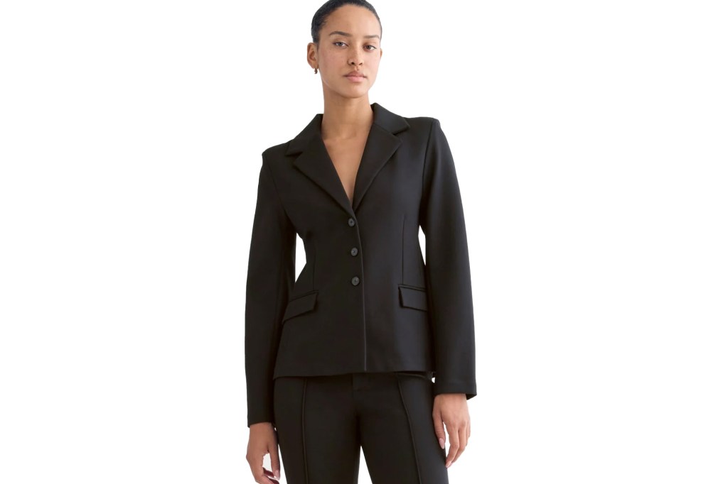 Woman in a black blazer and matching pants.