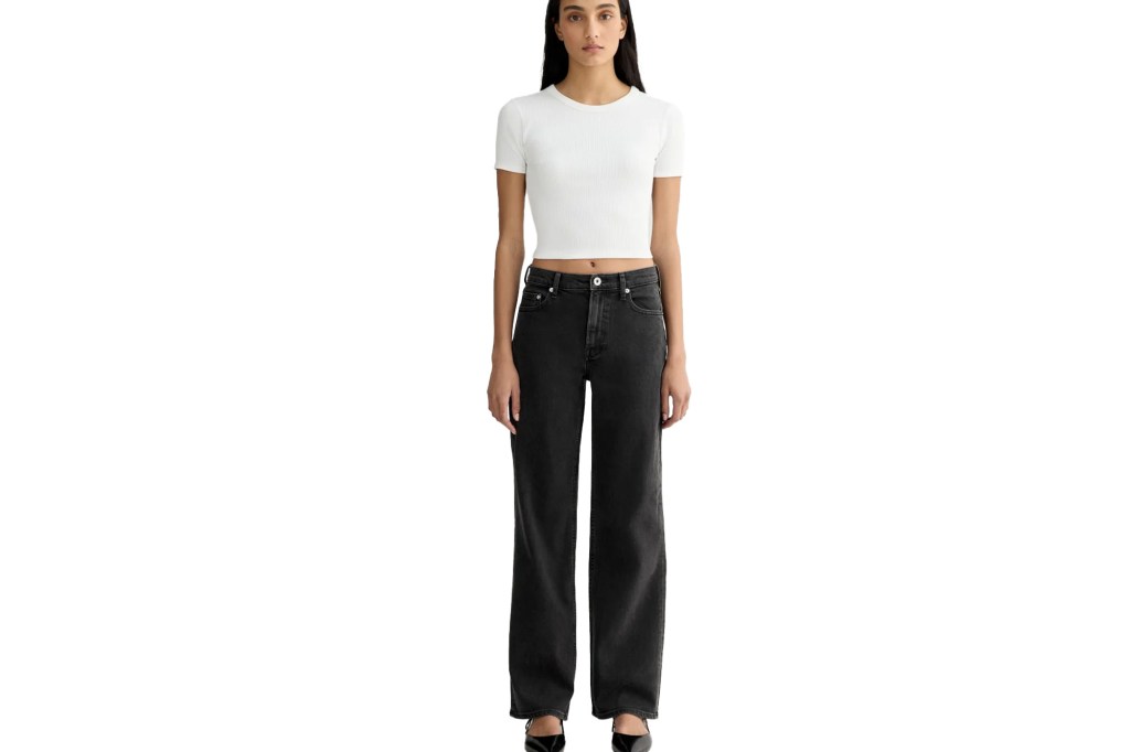 Woman wearing black wide-leg jeans and a white cropped t-shirt.