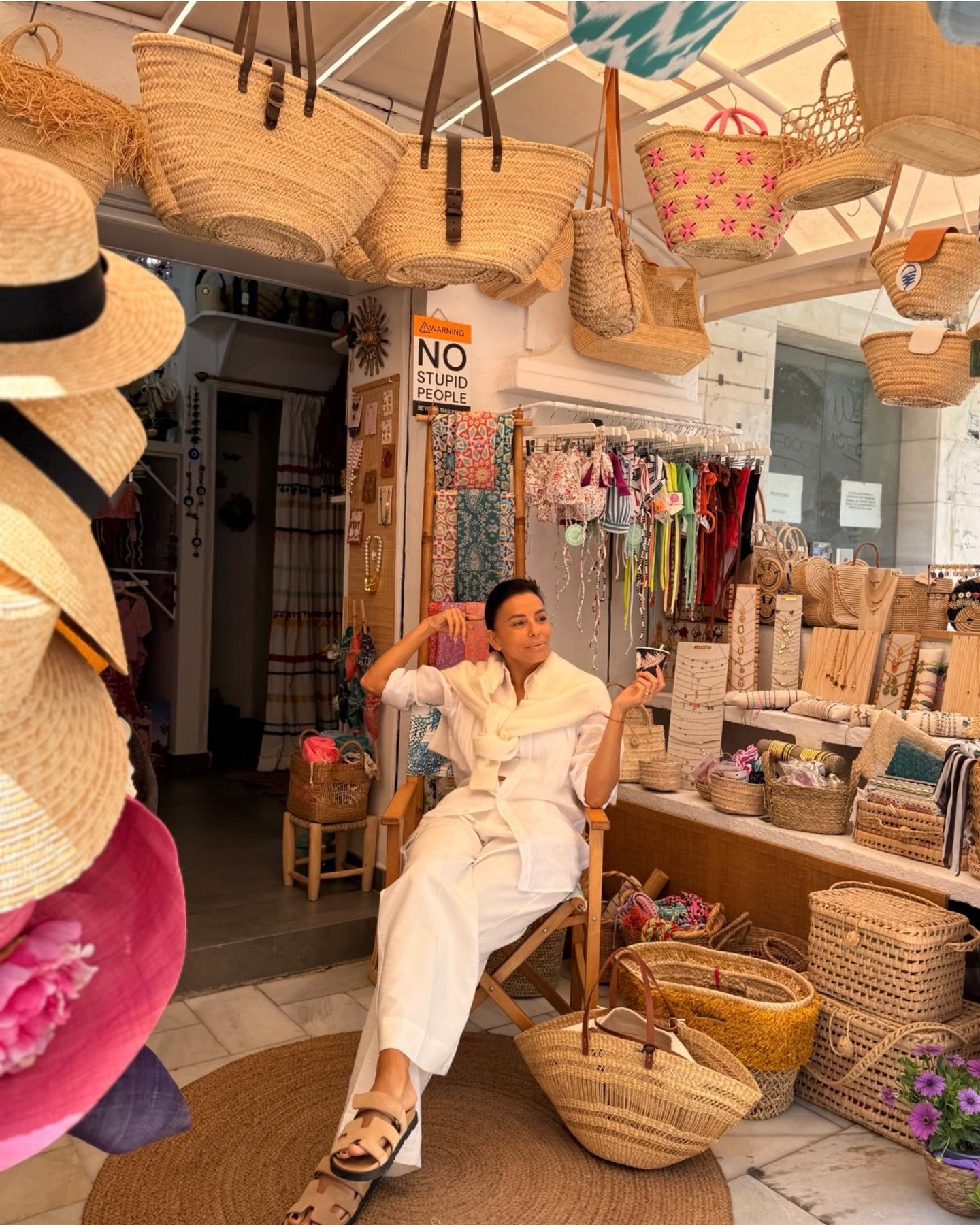 Eva Longoria gives her tired feet a rest as she chills in a gift shop while on vacation in her “happy place.”