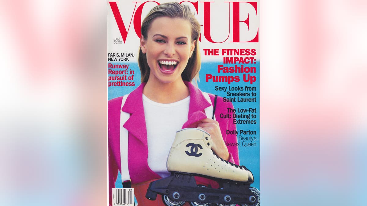 Model Niki Taylor poses for a Vogue cover wearing a pink Chanel jacket over a white T-shirt, carrying Chanel roller blades over her shoulder.