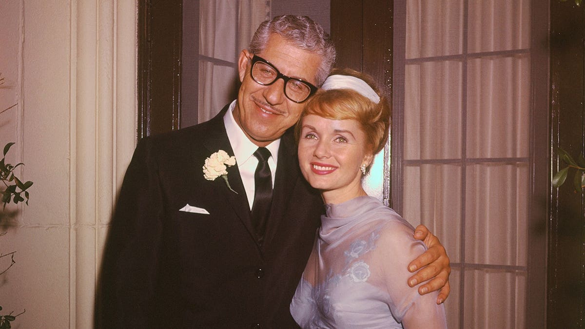 Actress Debbie Reynolds and husband Harry Karl posing on their wedding day.