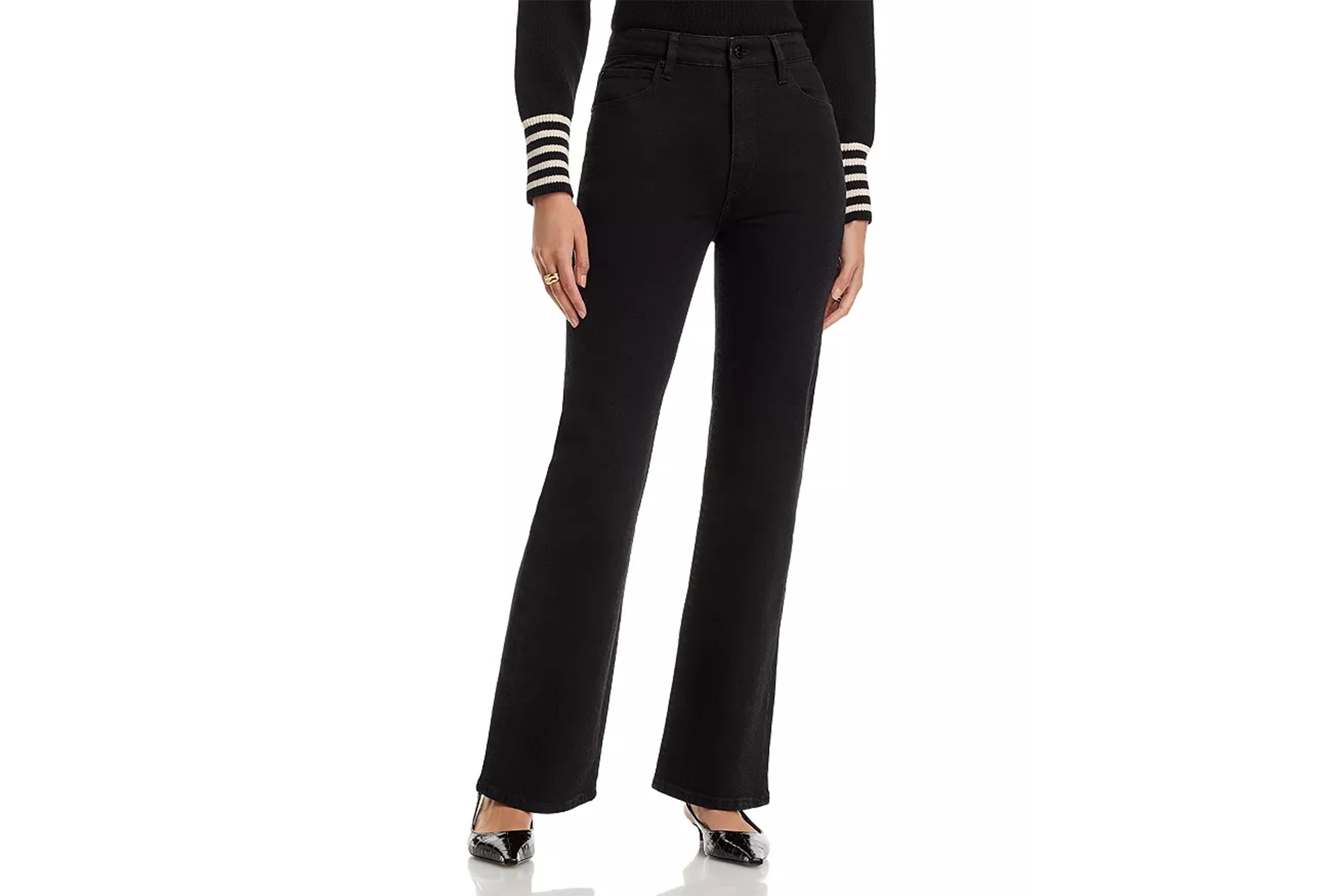 A person wearing black jeans, a black long-sleeved shirt with white and black striped cuffs, and black high-heeled shoes.