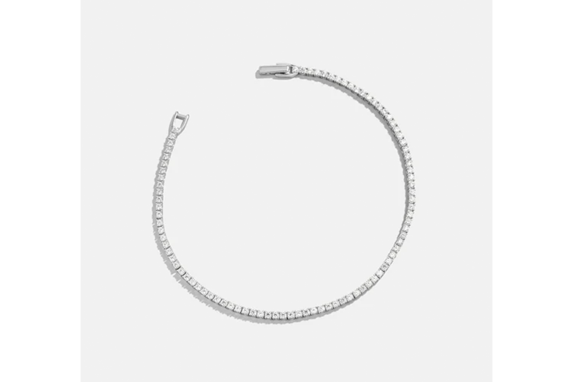 Diamond tennis bracelet with an open clasp.
