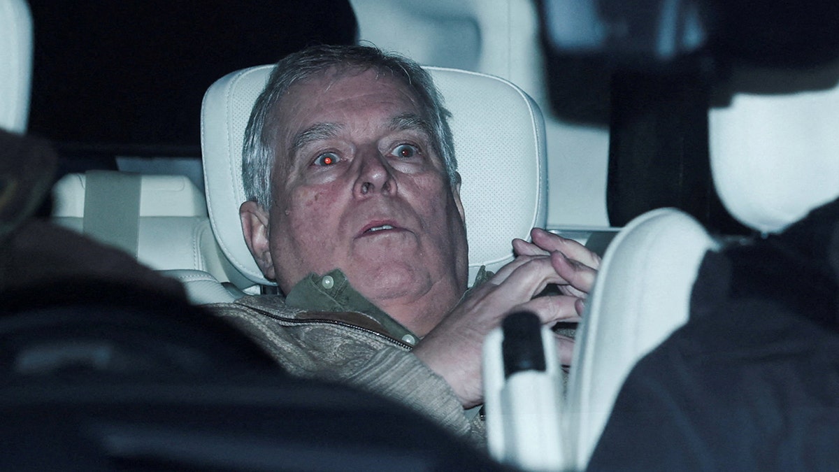 Andrew Mountbatten Windsor seated in a vehicle leaving Aylsham Police Station