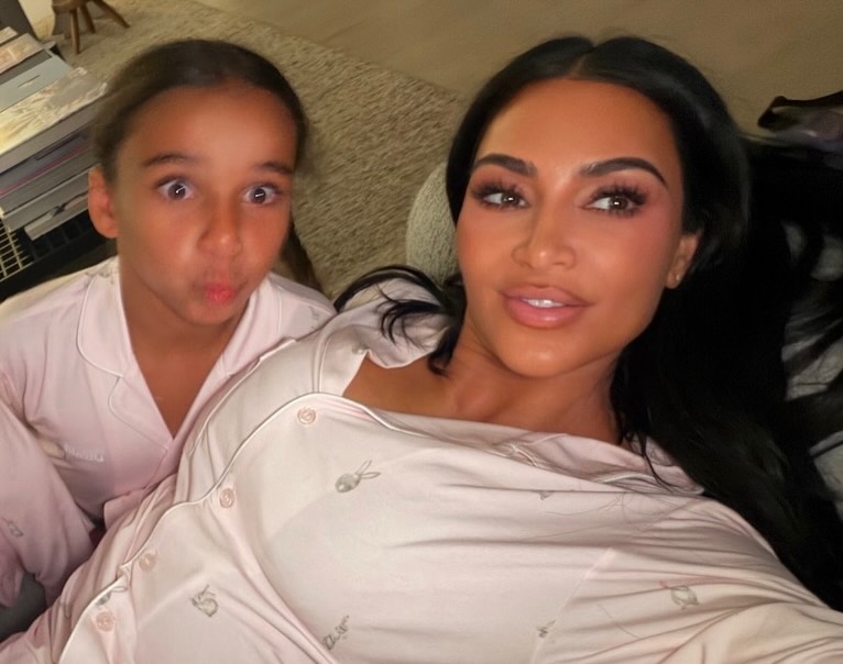 Kim Kardashian and her daughter in matching pink pajamas.