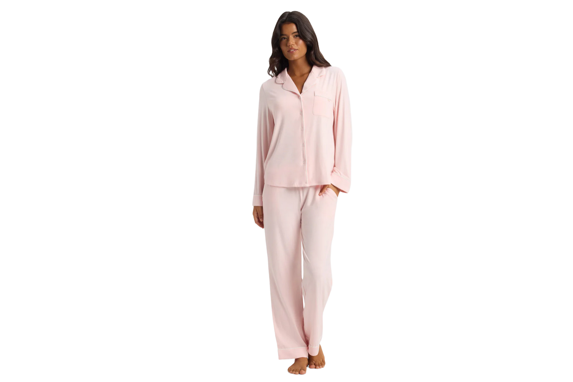 Woman in pink button-up pajama set with long sleeves and pants.