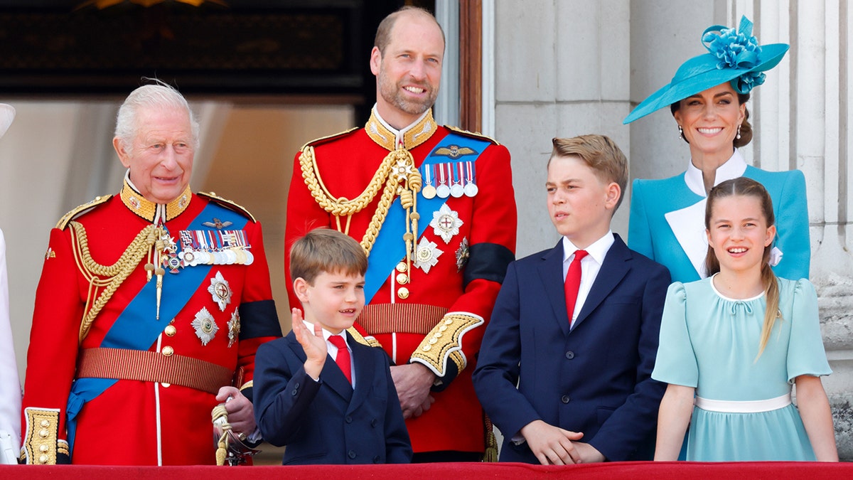 King Charles III and royal family watching RAF flypast from Buckingham Palace balcony
