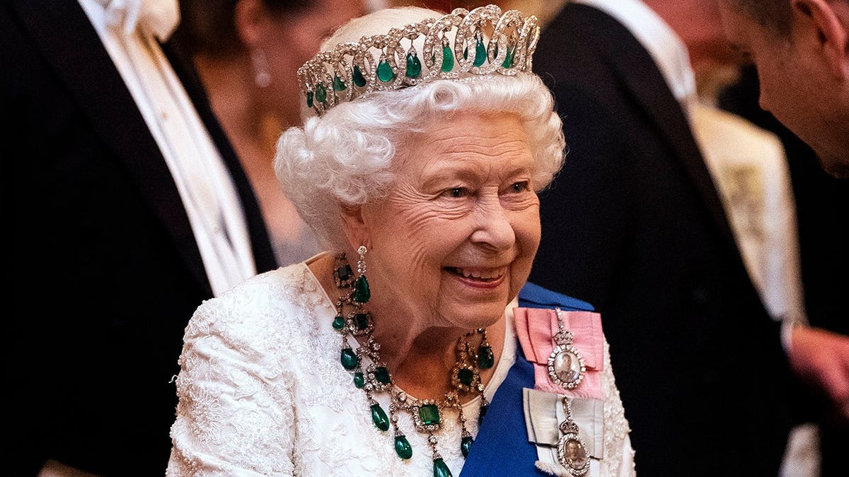 Queen Elizabeth II talking to guests at a reception at Buckingham Palace