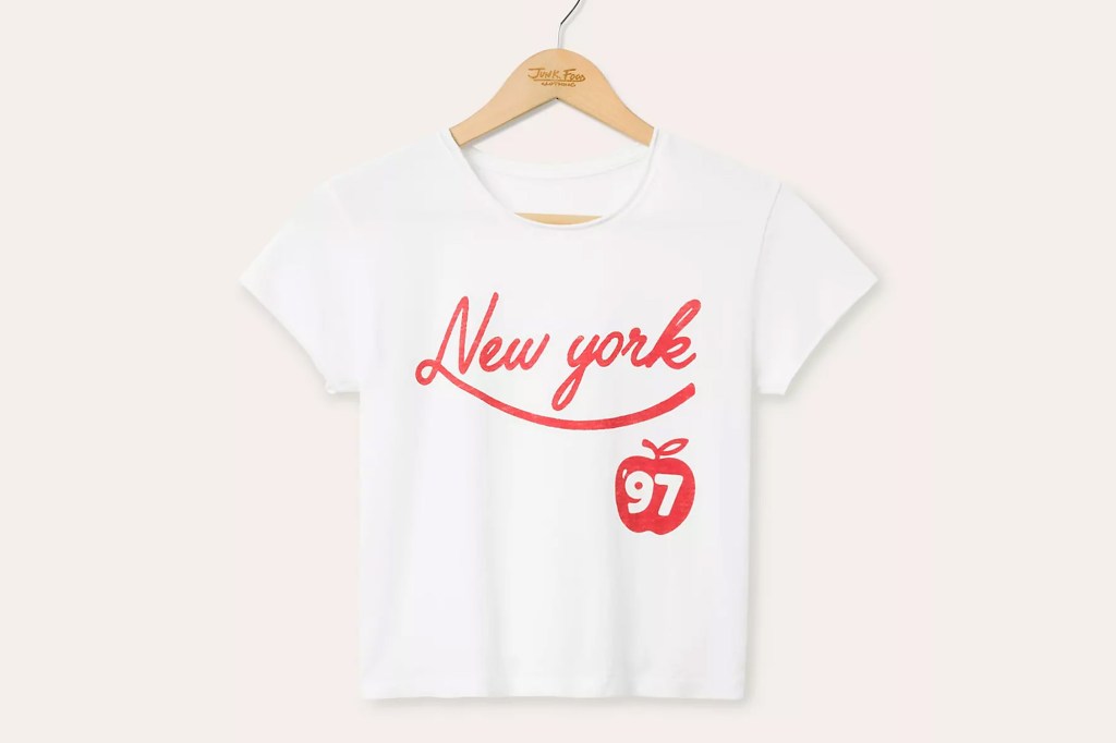 White t-shirt with "New York" in red script and a red apple with "97" on it.