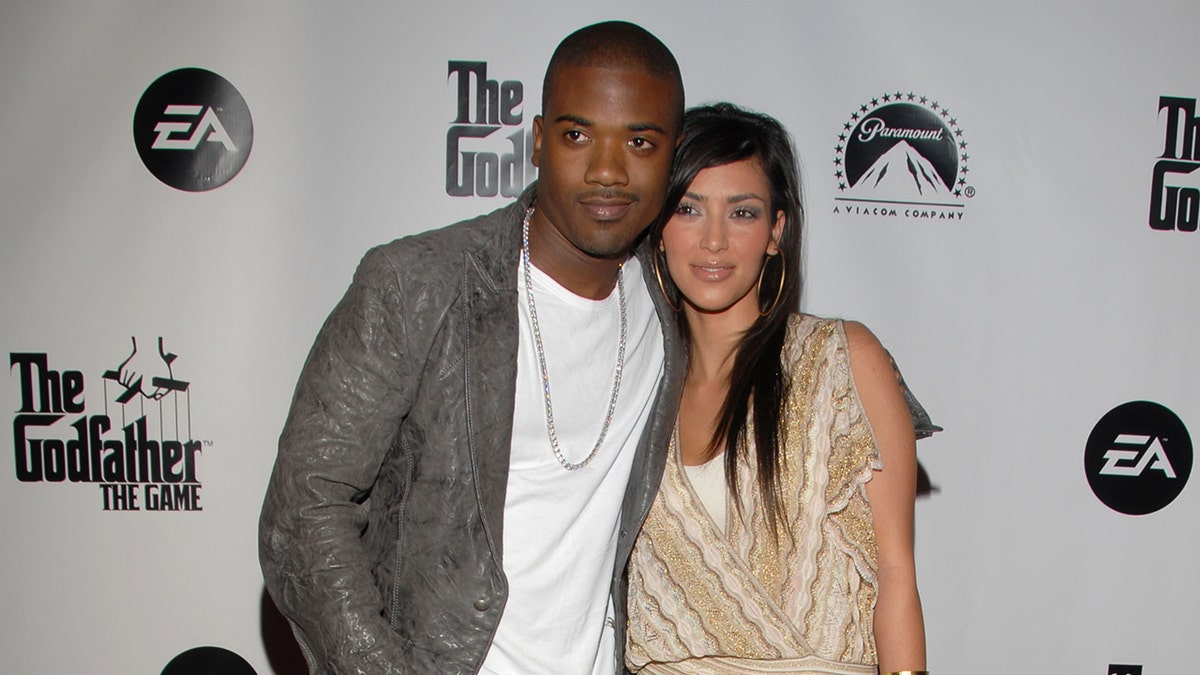 Ray J and Kim Kardashian posing together on a red carpet.