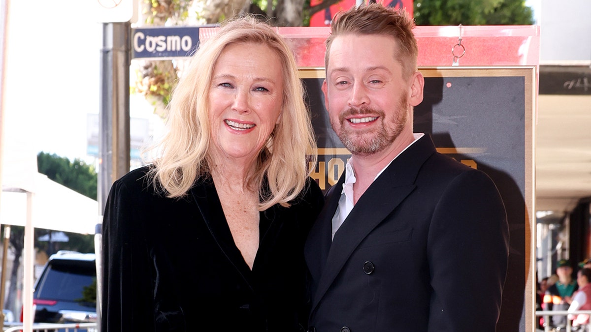 Macaulay Culkin and Catherine O'Hara standing at Hollywood Walk of Fame ceremony