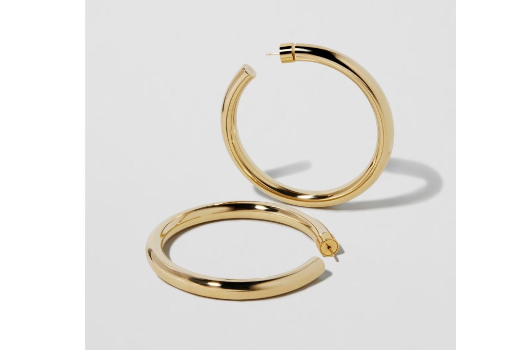 A pair of large, chunky gold hoop earrings.