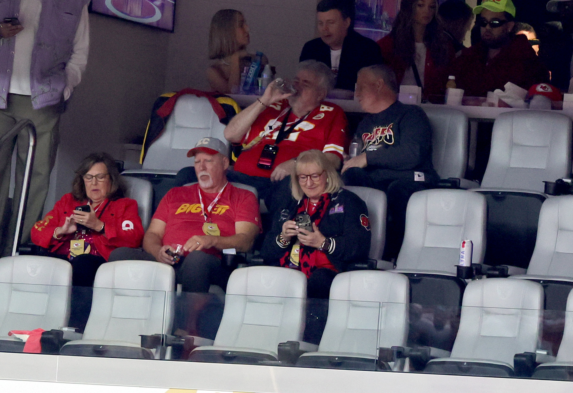 Donna Kelce, Ed Kelce, and Scott Swift sit in a suite at Super Bowl LVIII.