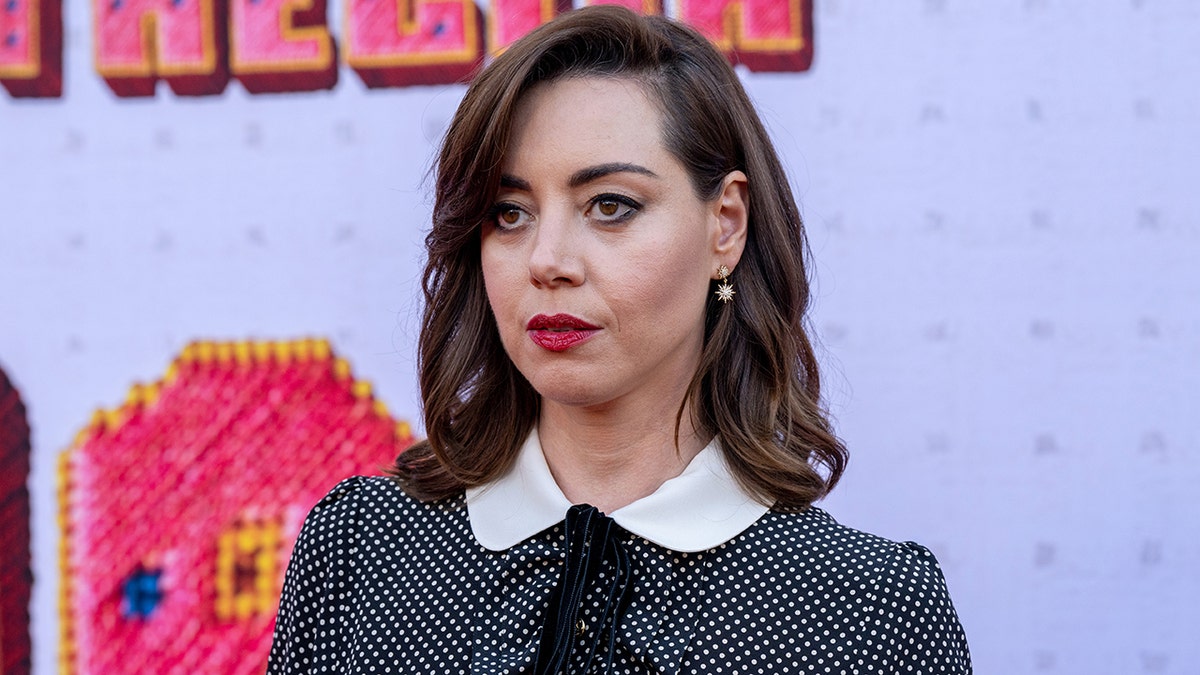 Actress Aubrey Plaza standing on red carpet at Thelma premiere in Los Angeles