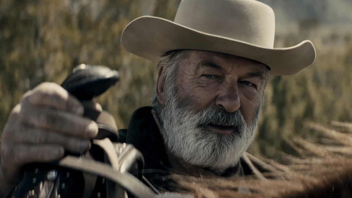 Alec Baldwin holding a prop gun on the set of Rust movie.