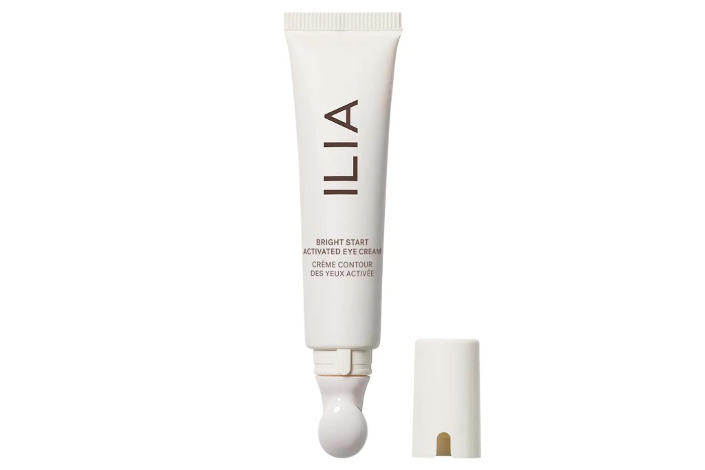 A white tube of ILIA Bright Start Activated Eye Cream with its cap off.