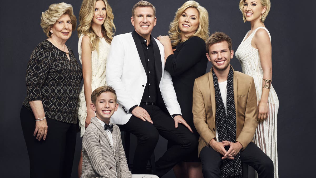 Todd Chrisley and family members standing together for a group photo.