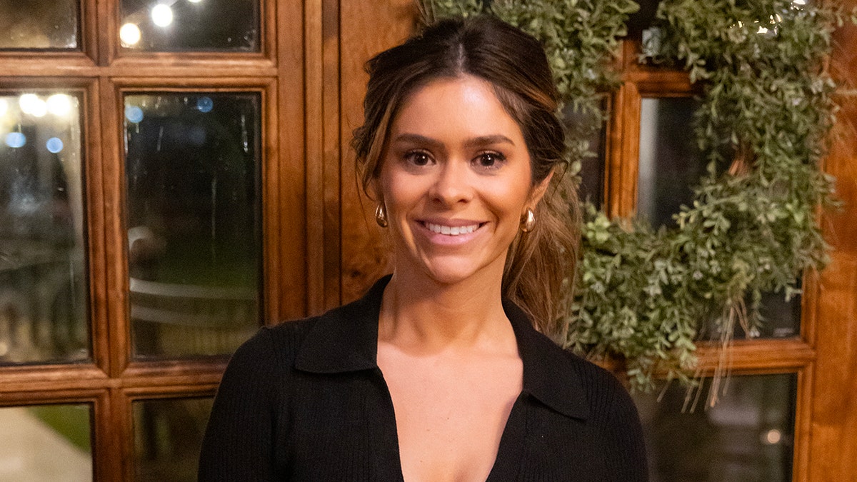 Taylor Frankie Paul wearing a black dress posing for a photo