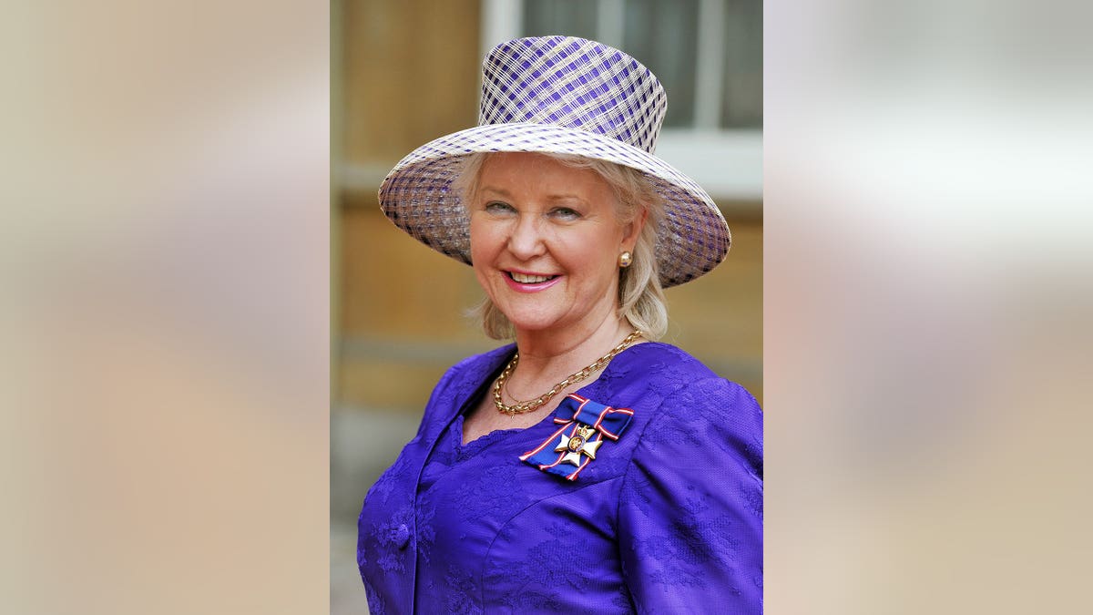 Angela Kelly wearing Royal Victorian Order medal at Buckingham Palace