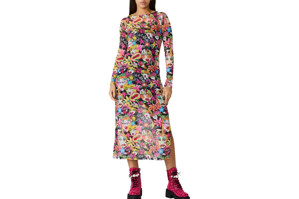 Woman wearing a Betsey Johnson mesh dress with pop-art faces and words, and pink combat boots with pearls.