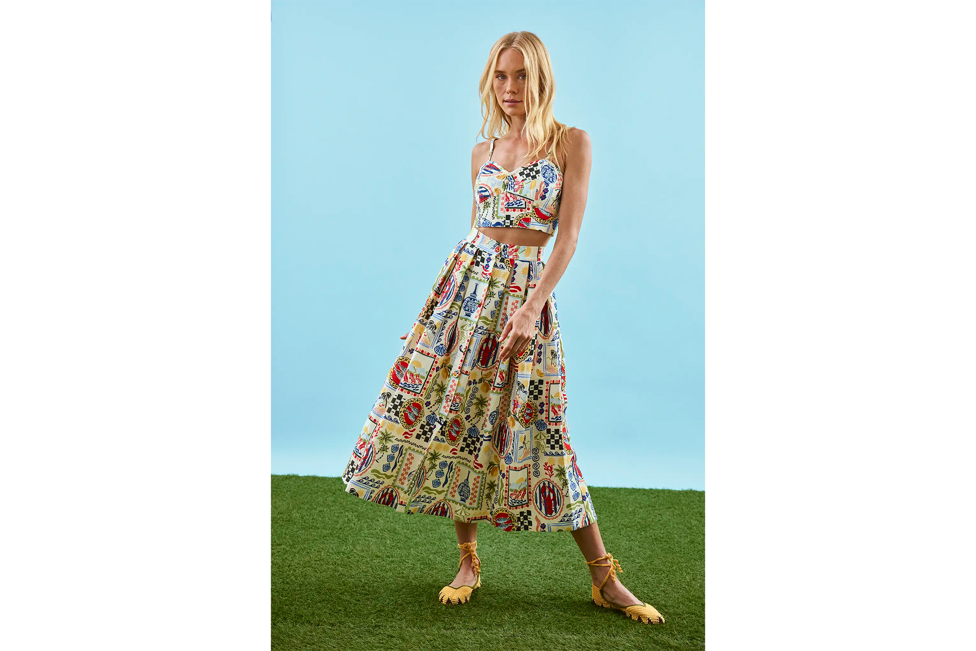 A woman poses in a Hunter Bell Brookie top and Eva skirt.